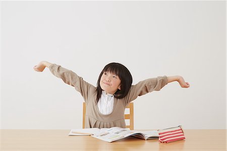 simsearch:859-07710990,k - Young girl doing her homework on wooden desk Stock Photo - Rights-Managed, Code: 859-07710997