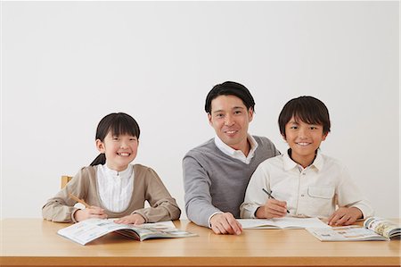 simsearch:859-07710990,k - Father helping son and daughter with homework Stock Photo - Rights-Managed, Code: 859-07711015