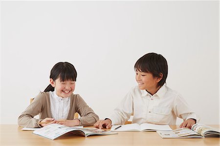 Kids doing their homework on wooden desk Stock Photo - Rights-Managed, Code: 859-07711010
