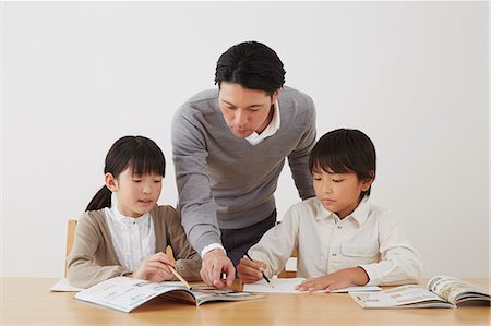 simsearch:859-07710990,k - Father helping son and daughter with homework Stock Photo - Rights-Managed, Code: 859-07711011