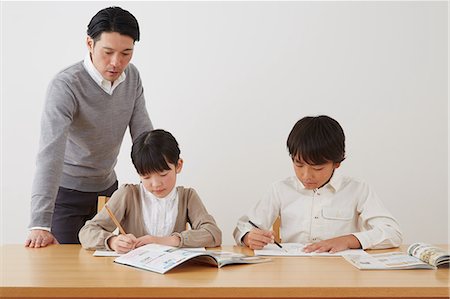 simsearch:859-07710990,k - Father helping son and daughter with homework Stock Photo - Rights-Managed, Code: 859-07711012