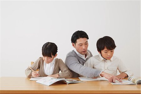 simsearch:859-07710990,k - Father helping son and daughter with homework Stock Photo - Rights-Managed, Code: 859-07711013