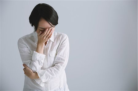 Desperate Japanese young woman in a white shirt Stock Photo - Rights-Managed, Code: 859-07711119