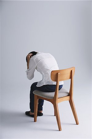 simsearch:859-09155276,k - Desperate Japanese young woman in a white shirt sitting on a chair Foto de stock - Con derechos protegidos, Código: 859-07711134