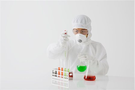 Young Japanese man in a protective suit working with chemicals Photographie de stock - Rights-Managed, Code: 859-08008337