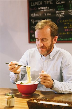 simsearch:859-06537942,k - Caucasian man with beard eating ramen noodles Stock Photo - Rights-Managed, Code: 859-08173132
