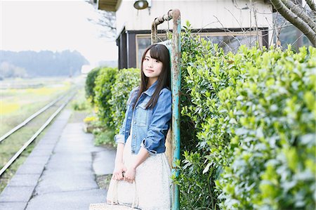 Attractive young Japanese woman at local train station in the Japanese countryside Stock Photo - Rights-Managed, Code: 859-08704137