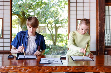 simsearch:859-03839113,k - Caucasian couple practicing calligraphy at traditional Japanese house Foto de stock - Con derechos protegidos, Código: 859-08887567