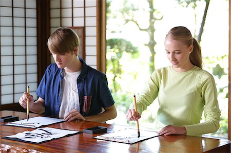 simsearch:859-08887641,k - Caucasian couple practicing calligraphy at traditional Japanese house Foto de stock - Direito Controlado, Número: 859-08887613