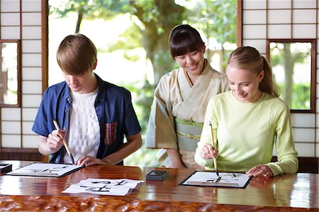 simsearch:859-08887641,k - Caucasian couple practicing calligraphy at traditional Japanese house Foto de stock - Direito Controlado, Número: 859-08887624