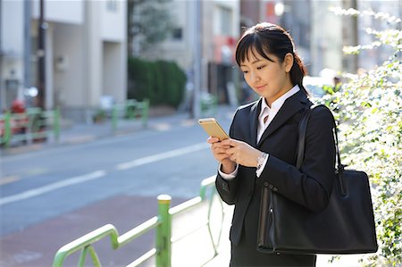 simsearch:859-08704133,k - Japanese young businesswoman with phone downtown Tokyo Stock Photo - Rights-Managed, Code: 859-08887651