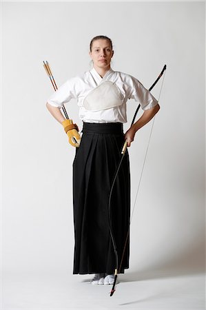 Caucasian woman practicing traditional Kyudo Japanese archery on white background Stock Photo - Rights-Managed, Code: 859-09018726