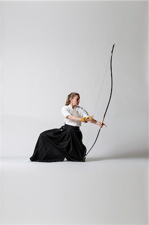 simsearch:859-09018730,k - Caucasian woman practicing traditional Kyudo Japanese archery on white background Stock Photo - Rights-Managed, Code: 859-09018736