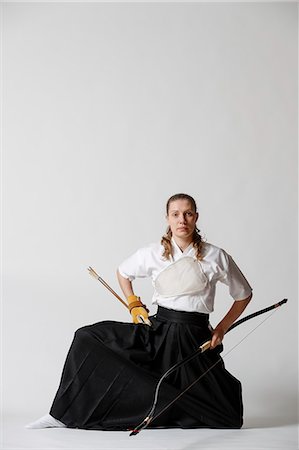 Caucasian woman practicing traditional Kyudo Japanese archery on white background Stock Photo - Rights-Managed, Code: 859-09018738