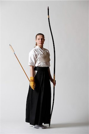 Caucasian woman practicing traditional Kyudo Japanese archery on white background Stock Photo - Rights-Managed, Code: 859-09018730