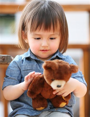 Mixed-race young girl with teddy bear Stock Photo - Rights-Managed, Code: 859-09018784