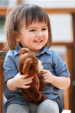 stuffed (people eating too much) - Mixed-race young girl with teddy bear Stock Photo - Rights-Managed, Code: 859-09018786