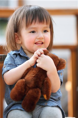 stuffed (people eating too much) - Mixed-race young girl with teddy bear Stock Photo - Rights-Managed, Code: 859-09018788