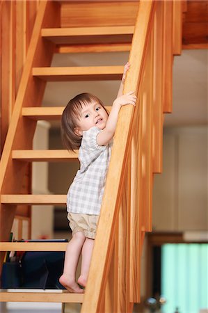 simsearch:859-09018844,k - Mixed-race young girl on wooden stairs Fotografie stock - Rights-Managed, Codice: 859-09018828