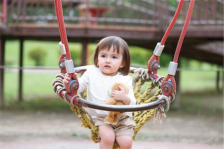 stuffed (people eating too much) - Mixed-race young girl playing at the park Stock Photo - Rights-Managed, Code: 859-09018839