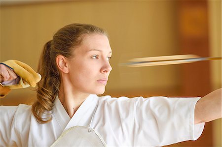 simsearch:859-09018730,k - Caucasian woman practicing traditional Kyudo Japanese archery Stock Photo - Rights-Managed, Code: 859-09018854