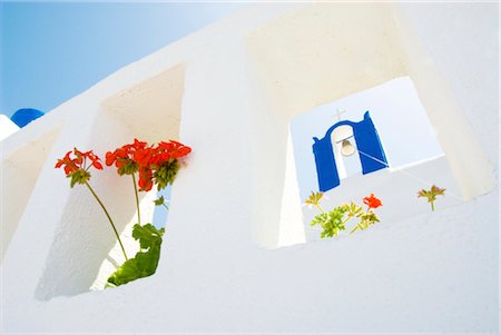 Red flowers in white openings in wall Stock Photo - Rights-Managed, Code: 859-03036535