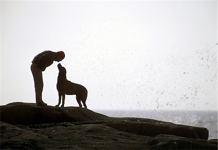 silhouettes man and dog - Person with dog by ocean Stock Photo - Rights-Managed, Code: 859-03036852