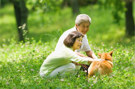 simsearch:859-03037420,k - Couple Petting Dog Stock Photo - Rights-Managed, Code: 859-03037442