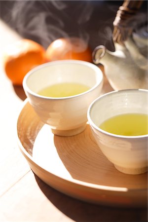 Cups of green tea on tray,and tangerines Stock Photo - Rights-Managed, Code: 859-03037908