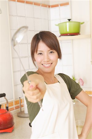 simsearch:859-03038475,k - Front view of a woman holding ladle Stock Photo - Rights-Managed, Code: 859-03038478