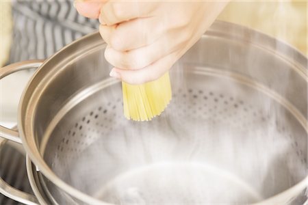 steaming noodles - Close-up of a hand cooking noodles Stock Photo - Rights-Managed, Code: 859-03038484