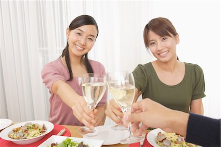 Front view of women enjoying champagne at dinner table Stock Photo - Rights-Managed, Code: 859-03038497