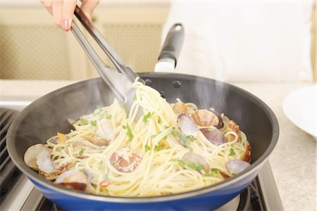 pasta tong - Hand of a person frying noodles Stock Photo - Rights-Managed, Code: 859-03038492