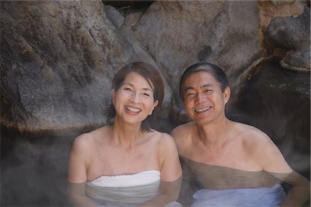 Middle-aged couple relaxing in natural hot spring Stock Photo - Rights-Managed, Code: 859-03038559