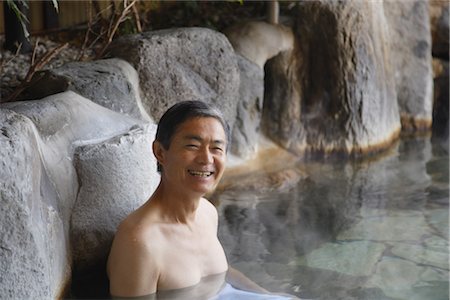 Front view of a man relaxing in natural hot spring Stock Photo - Rights-Managed, Code: 859-03038571