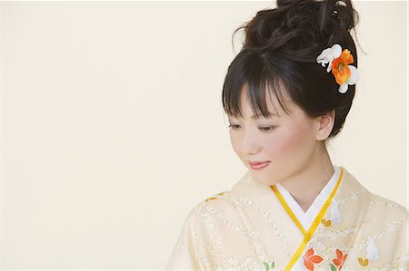 Japanese Woman with Hair Bun Looking Down Stock Photo - Rights-Managed, Code: 859-03038705