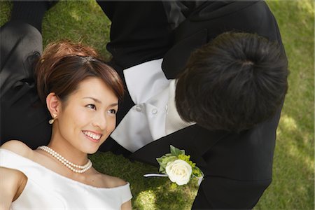 string of pearls for wedding - Bride and Groom Laying on Grass Stock Photo - Rights-Managed, Code: 859-03039123