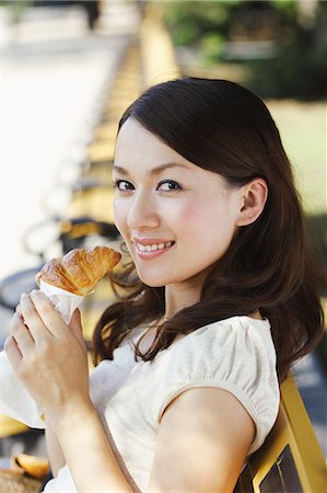 Young Japanese Woman Eating Hot Bun Stock Photo - Rights-Managed, Code: 859-03039394
