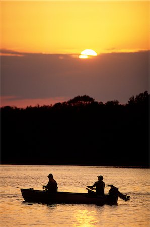 Silhouette two people fishing Stock Photos - Page 1 : Masterfile