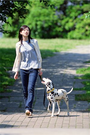 female dalmatian - Woman and Dog Walking In Park Stock Photo - Rights-Managed, Code: 859-03041057