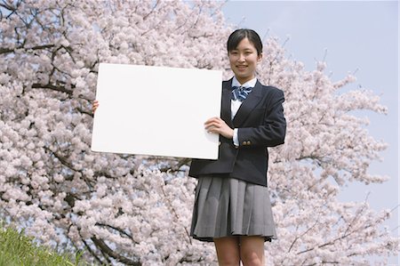 Schoolgirl Standing in Park Holding Whiteboard Stock Photo - Rights-Managed, Code: 859-03599029