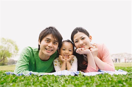 Parents and Daughter Lying on Grass Stock Photo - Rights-Managed, Code: 859-03599178