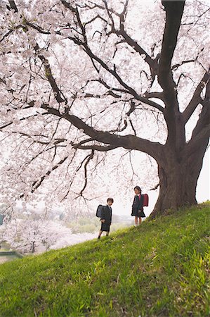 Schoolmates Holding Satchels Standing in Park Stock Photo - Rights-Managed, Code: 859-03599171