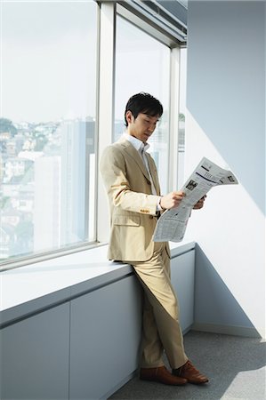 executive office profile - Young Executive Businessman Reading  Newspaper Stock Photo - Rights-Managed, Code: 859-03599195