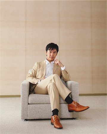 executive suited man sitting - Young Executive Businessman Stock Photo - Rights-Managed, Code: 859-03599201