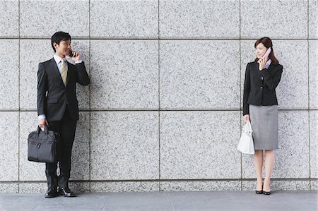 Businessman And Businesswoman Talking On The Phone Foto de stock - Con derechos protegidos, Código: 859-03599240