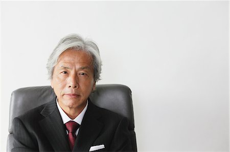 executive suited man sitting - Executive Businessman Stock Photo - Rights-Managed, Code: 859-03599302