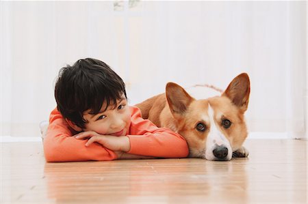 dog and boy - Pembroke Welsh Corgi And Boy Relaxing Stock Photo - Rights-Managed, Code: 859-03599479