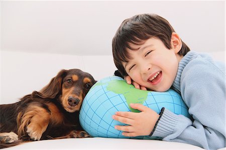 Miniature Dachshund And A Boy Relaxing Stock Photo - Rights-Managed, Code: 859-03599486