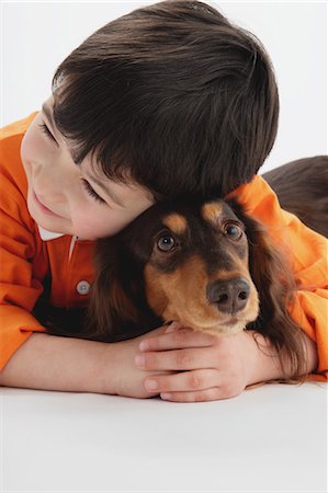 simsearch:859-03599527,k - Miniature Dachshund And A Boy Stock Photo - Rights-Managed, Code: 859-03599537